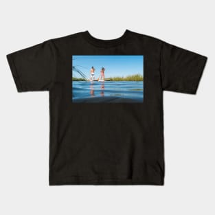 Man and woman stand up paddleboarding Kids T-Shirt